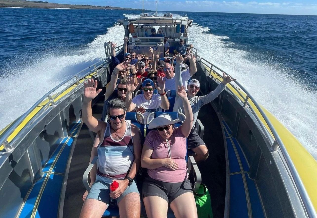 Guests riding in forward-facing seats on a super raft
