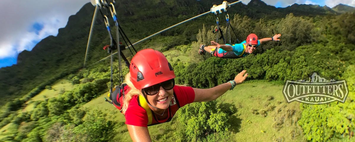 Two guests fly headfirst on the AdrenaLine tour at Kīpū Ranch