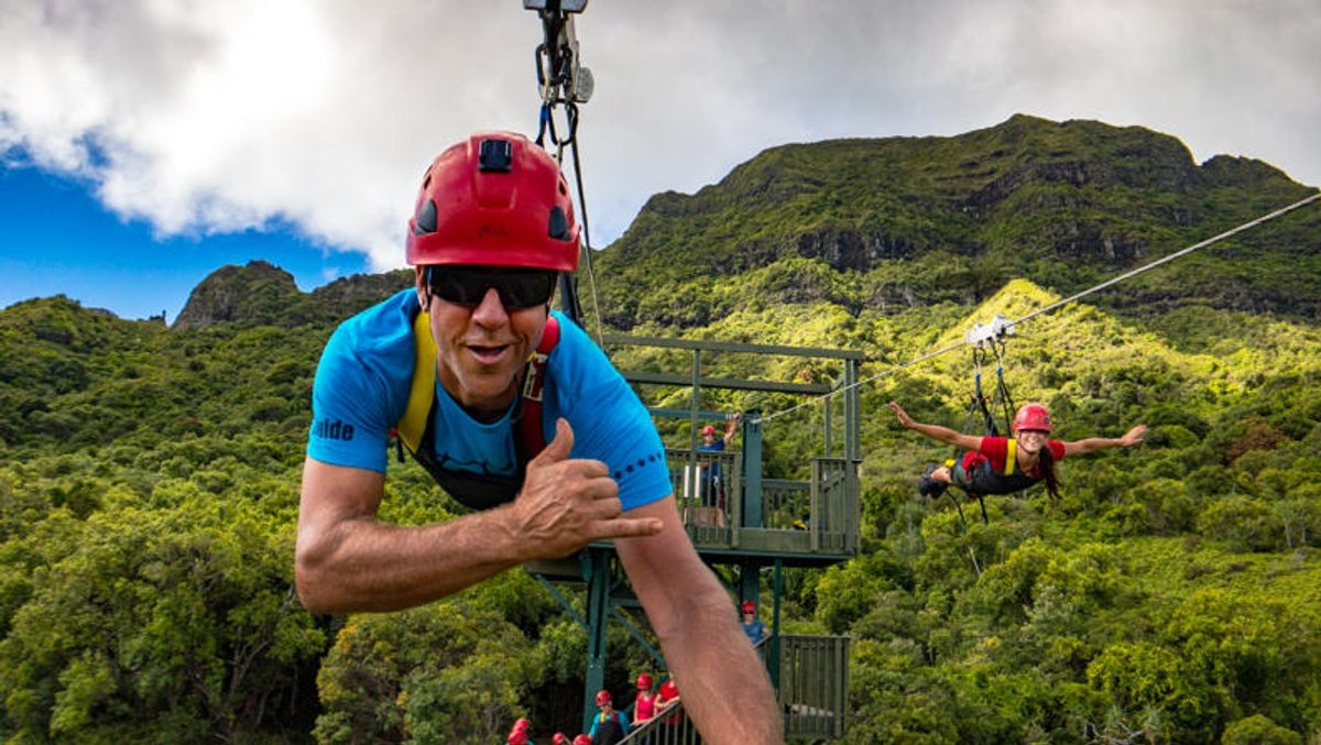 Two riders fly side by side on the FlyLine portion of Zip & Splash
